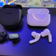 Photo of the Bose QuietComfort II next to the 1st Gen Apple AirPods Pro